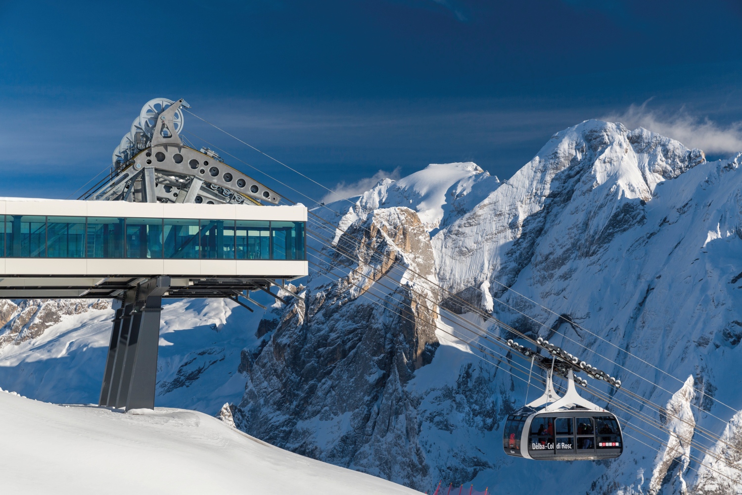 Cable car next to snow covered mountain, Val di Fassa